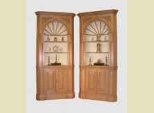 George III style corner cupboards with detailed carved spandrels